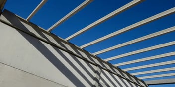 close up of a grey building and blue sky