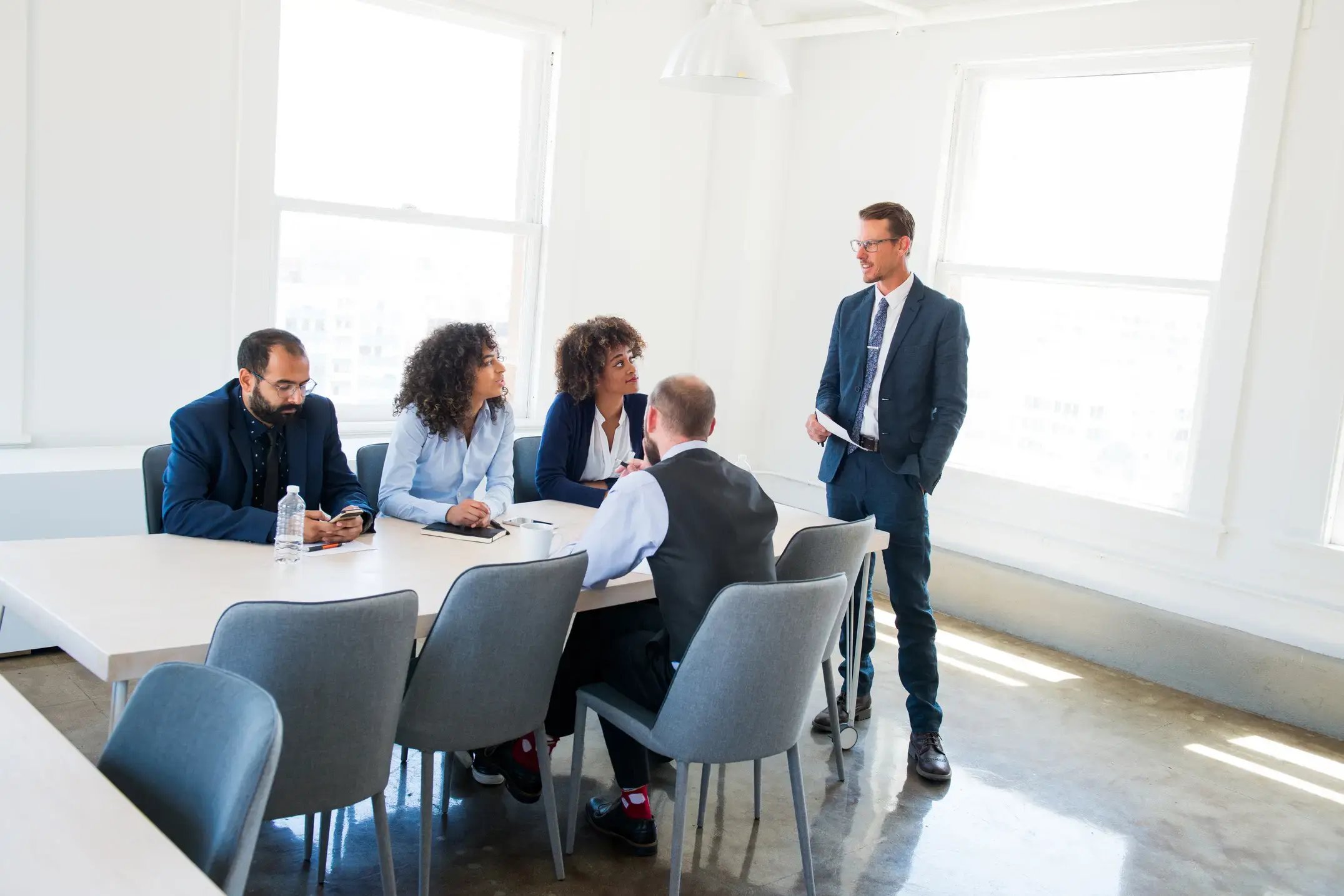  Business team in a modern office engaged in a discussion during a professional meeting. 