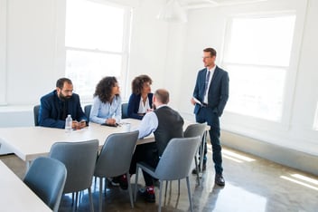 Business team in a modern office engaged in a discussion during a professional meeting.
