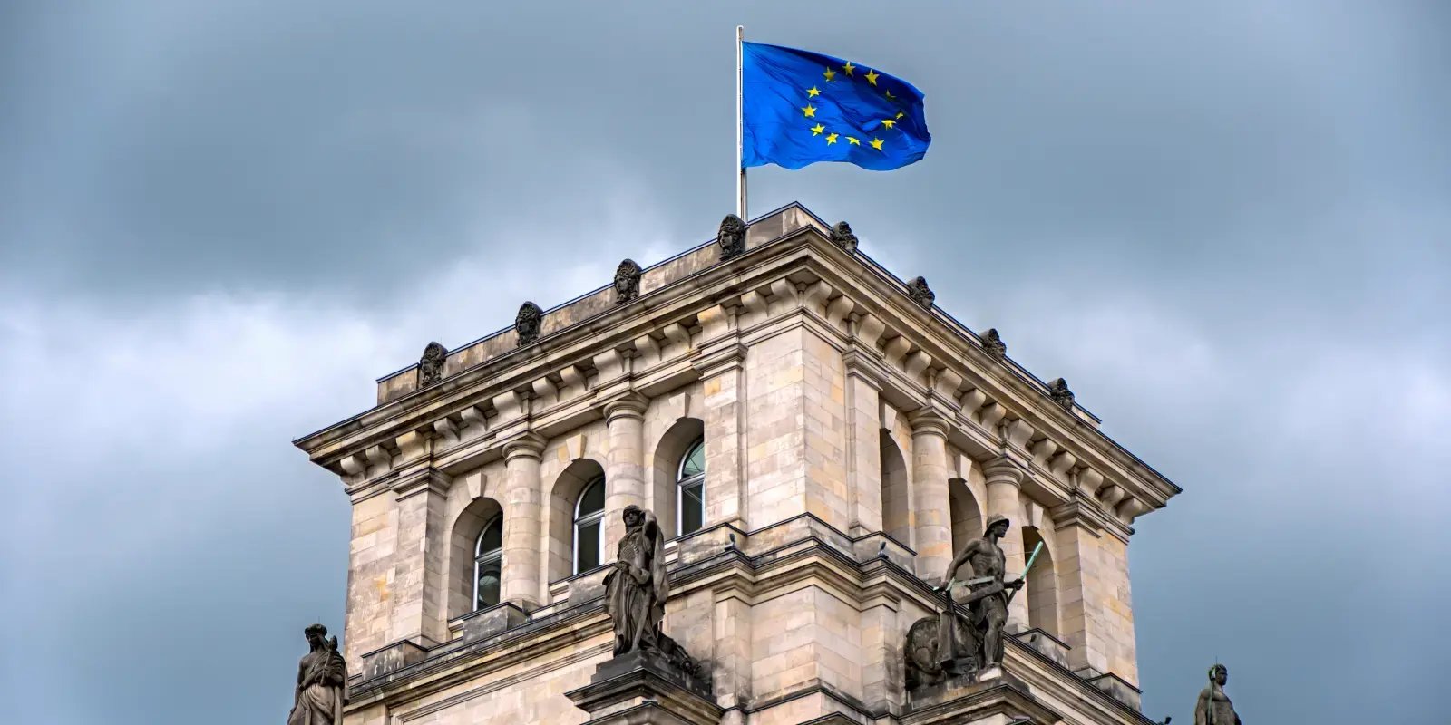  european union building with an eu flag waving in the wind 