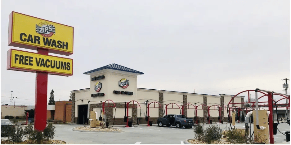  Zips Car Wash exterior with signage and vacuum stations in a spacious parking lot. 