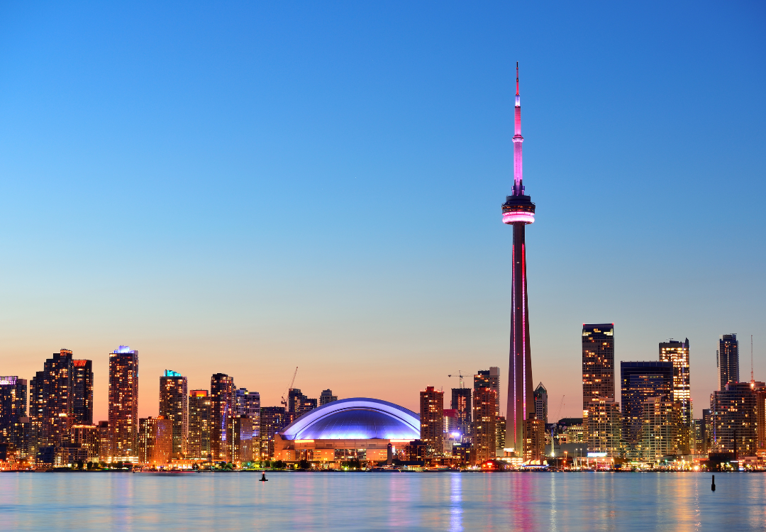 toronto city skyline with the CN towner and rogers arena in view at dusk