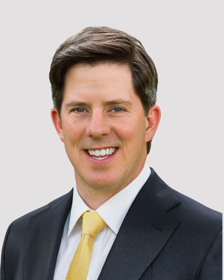 A professional man with short brown hair.