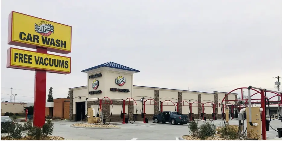 Zips Car Wash exterior with signage and vacuum stations in a spacious parking lot.